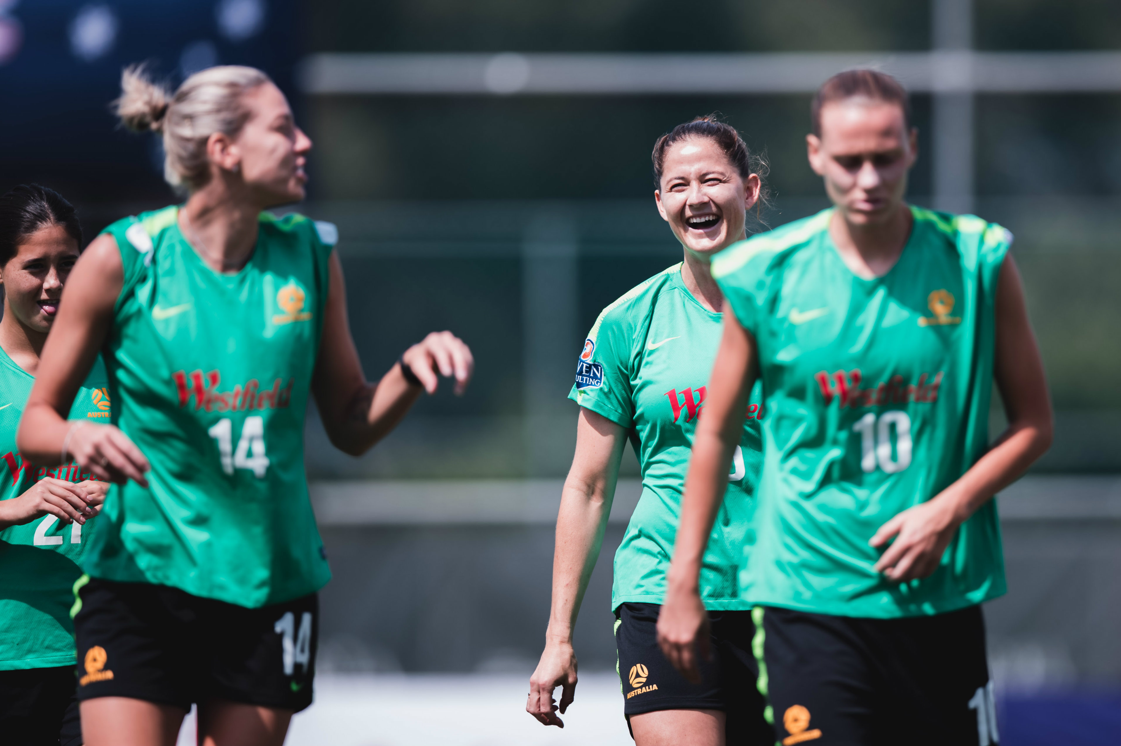Laura Alleway shares a joke with Alanna Kennedy on the first day in camp