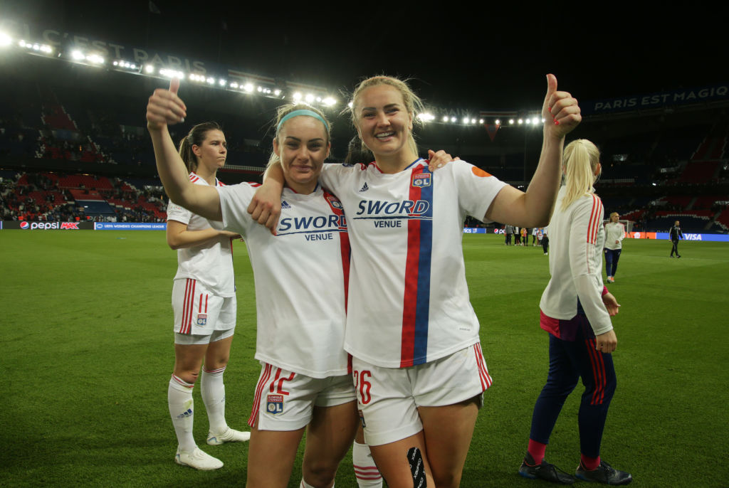 Ellie Carpenter (#12) and Lindsey Horan (#26) of Lyon celebrate after winning the UEFA Women's Champions League Semi Final Second Leg match between Paris Saint-Germain and Olympique Lyon at Parc des Princes on April 30, 2022 in Paris, France. (Photo by Johannes Simon - UEFA/UEFA via Getty Images)