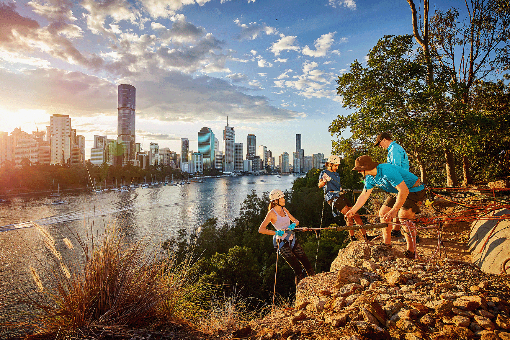 One female and one male cliff climbers getting ready with two staff Kangaroo Point (Photo Provided: Tourism and Events Queensland)