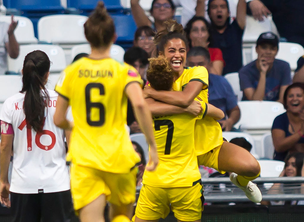 Jamaica's Kalyssa van Zanten (R) celebrates with teammates after scoring a goal against Costa Rica during their 2022 Concacaf women's championship third-place football match, at the BBVA Bancomer stadium in Monterrey, Nuevo Leon State, Mexico on July 18, 2022. (Photo by Julio Cesar AGUILAR / AFP) (Photo by JULIO CESAR AGUILAR/AFP via Getty Images)