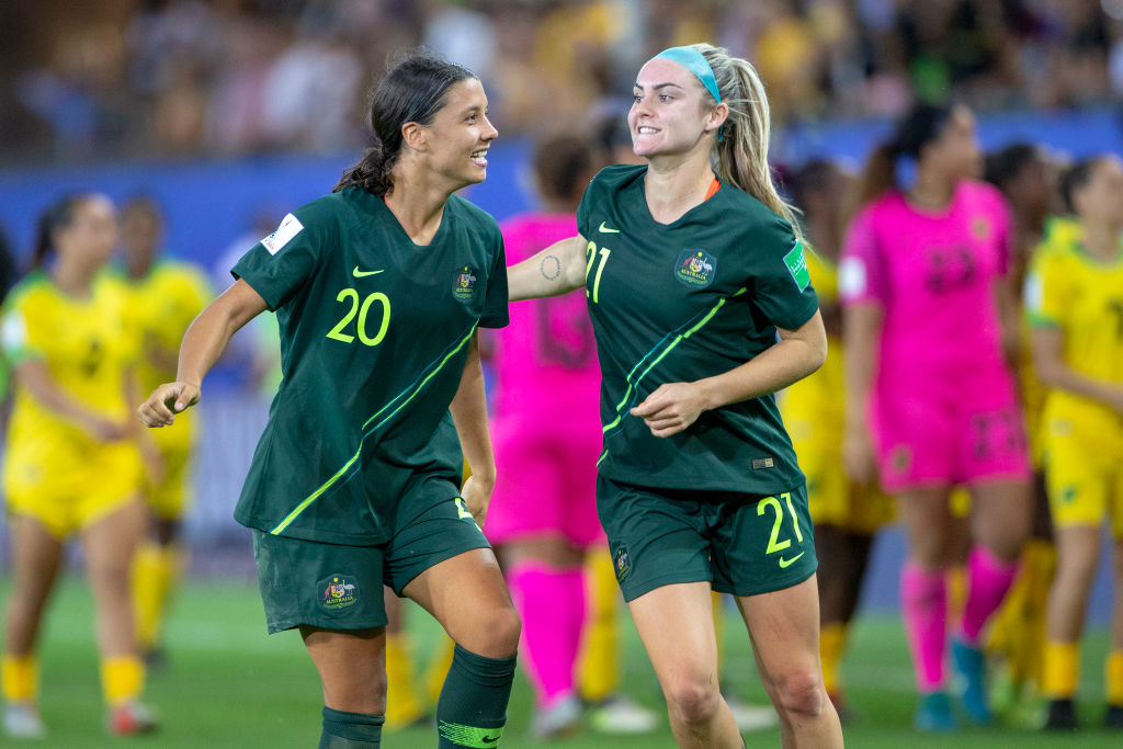 Sam Kerr #20 of Australia, after scoring four goals, celebrates with teammate Ellie Carpenter #21 of Australia at the end of the game during the Jamaica V Australia, Group C match at the FIFA Women's World Cup at Stade des Alpes on June 18th 2019 in Grenoble, France.