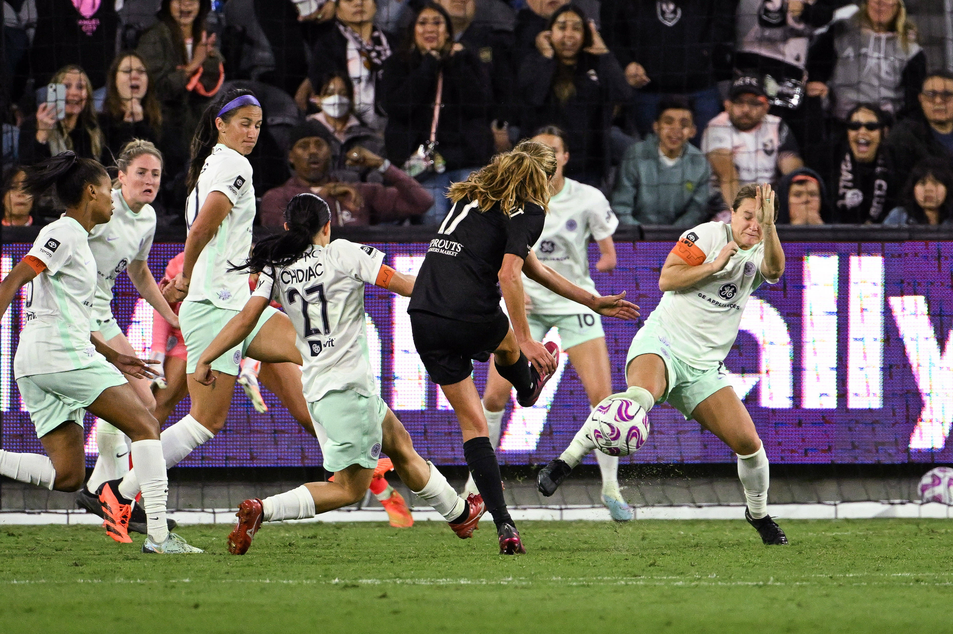 Angel City FC midfielder Dani Weatherholt (17) takes a shot against Racing Louisville FC midfielder Lauren Milliet (2) as midfielder Alex Chidiac (27) defends in the second half at BMO Stadium. Los Angeles Angel City FC midfielder Dani Weatherholt (17) takes a shot against Racing Louisville FC midfielder Lauren Milliet (2) as midfielder Alex Chidiac (27) defends in the second half at BMO Stadium. Los Angeles