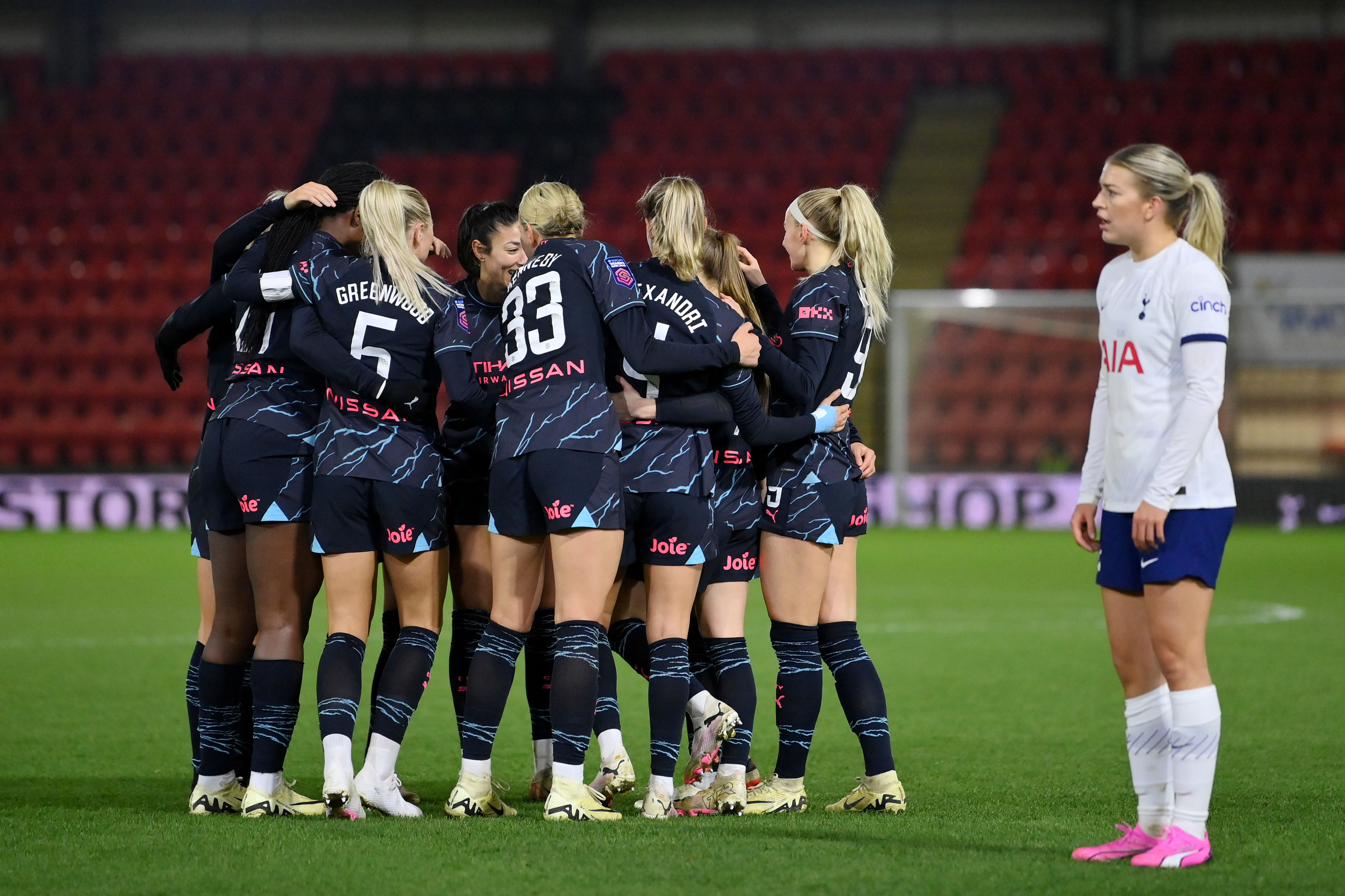 Yui Hasegawa of Manchester City (hidden) celebrates scoring her team's first goal with teammates during the FA Women's Continental Tyres League Cup Quarter Final match between Tottenham Hotspur and Manchester City at Brisbane Road on February 07, 2024 in London, England. (Photo by Justin Setterfield/Getty Images)
