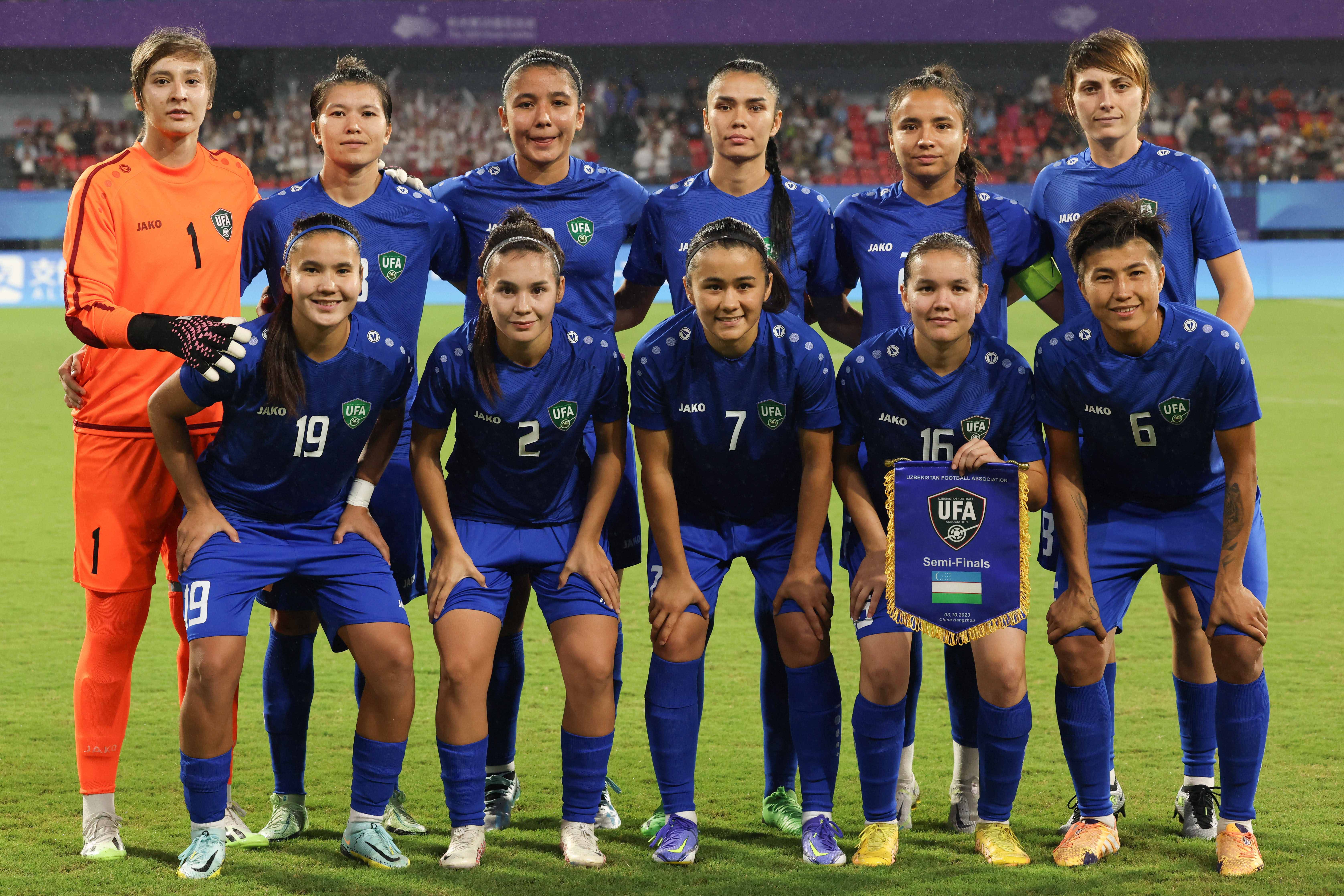 Athletes of Uzbekistan pose before the Women s Semifinal between Uzbekistan and the Democratic People s Republic of Korea (DPRK) at the 19th Asian Games in Hangzhou