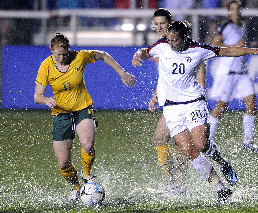  Abby Wambach #20 of the U.S. Women's National Team and Clare Polkinghome #11 of the Australian Women's National Team send up a spray of water as they battle for the ball during an international friendly match April 27, 2008, at WakeMed Soccer Park in Cary, North Carolina. The U.S. won 3-2 in stoppage time. (Photo By Grant Halverson/Getty Images)