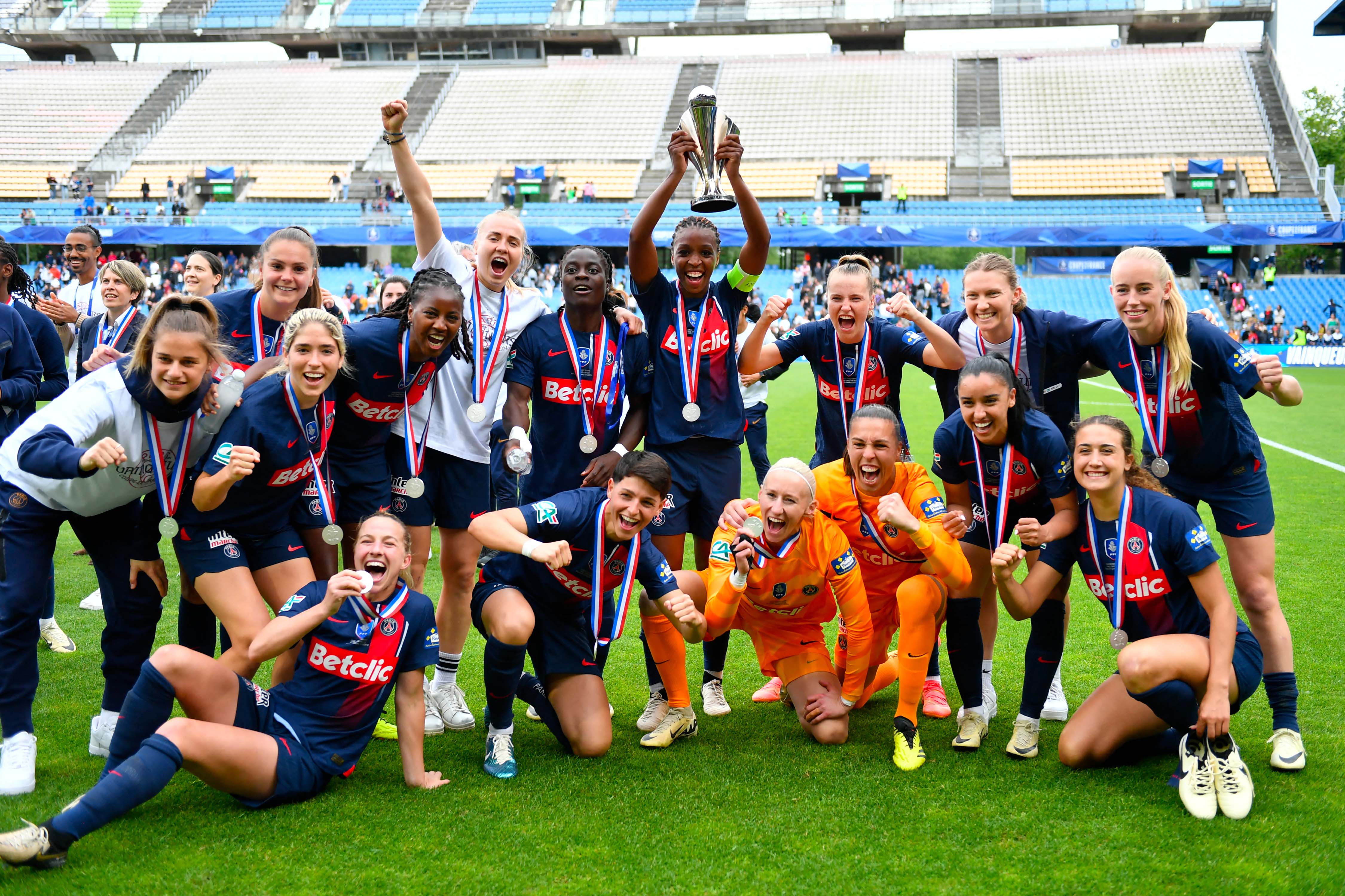 Paris Saint Germain's players celebrate with the trophy after winning the Women's French Cup (Coupe de France) final football match between Paris Saint-Germain (PSG) and FC Fleury 91 at the Mosson Stadium in Montpellier, southern France, on May 4, 2024. (Photo by Sylvain THOMAS / AFP) (Photo by SYLVAIN THOMAS/AFP via Getty Images)