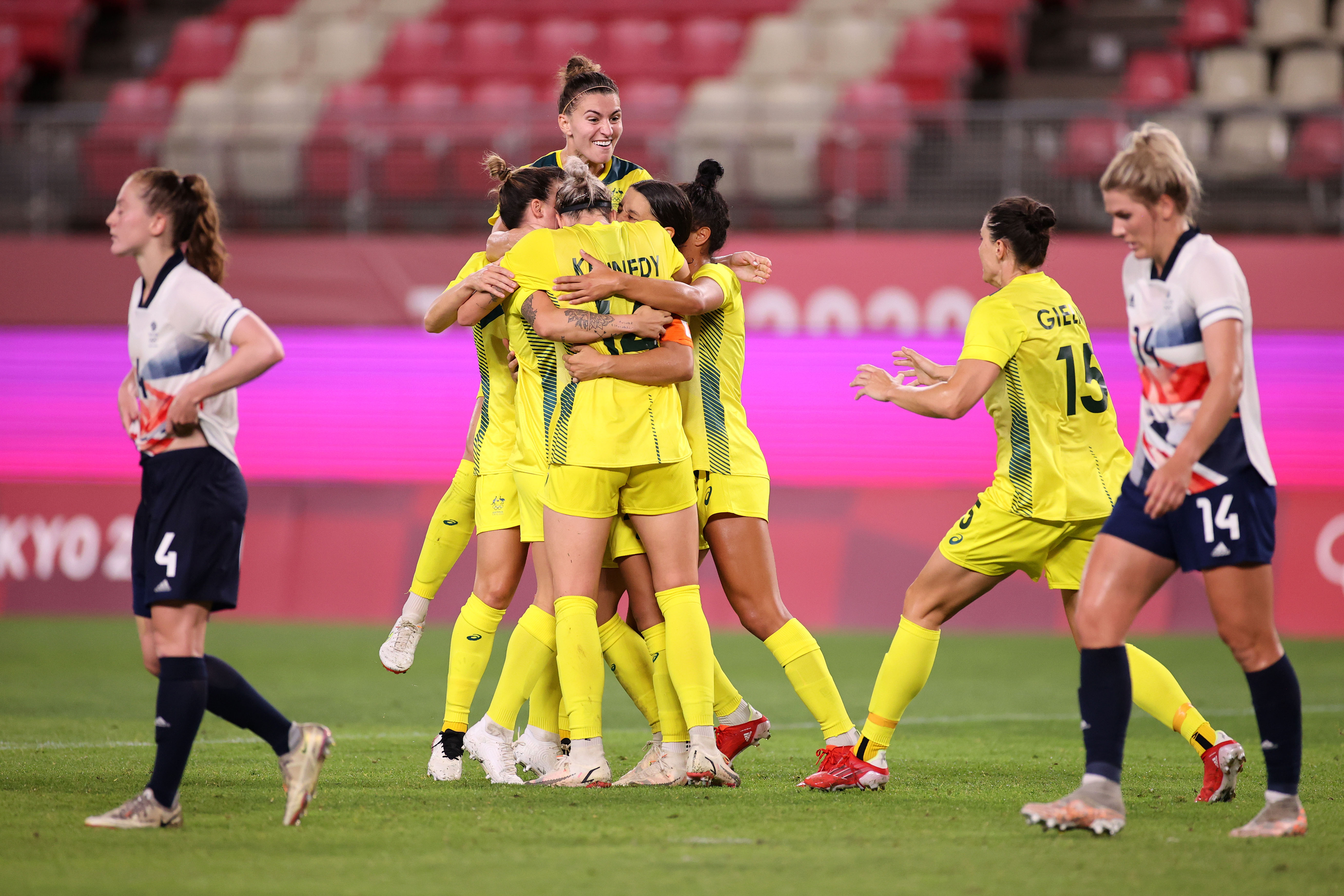 Sam Kerr #2 of Team Australia (obscured) celebrates with Alanna Kennedy #14 after scoring their side's second goal during the Women's Quarter Final match between Great Britain and Australia on day seven of the Tokyo 2020 Olympic Games at Kashima Stadium on July 30, 2021 in Kashima, Ibaraki, Japan. (Photo by Hector Vivas - FIFA/FIFA via Getty Images)