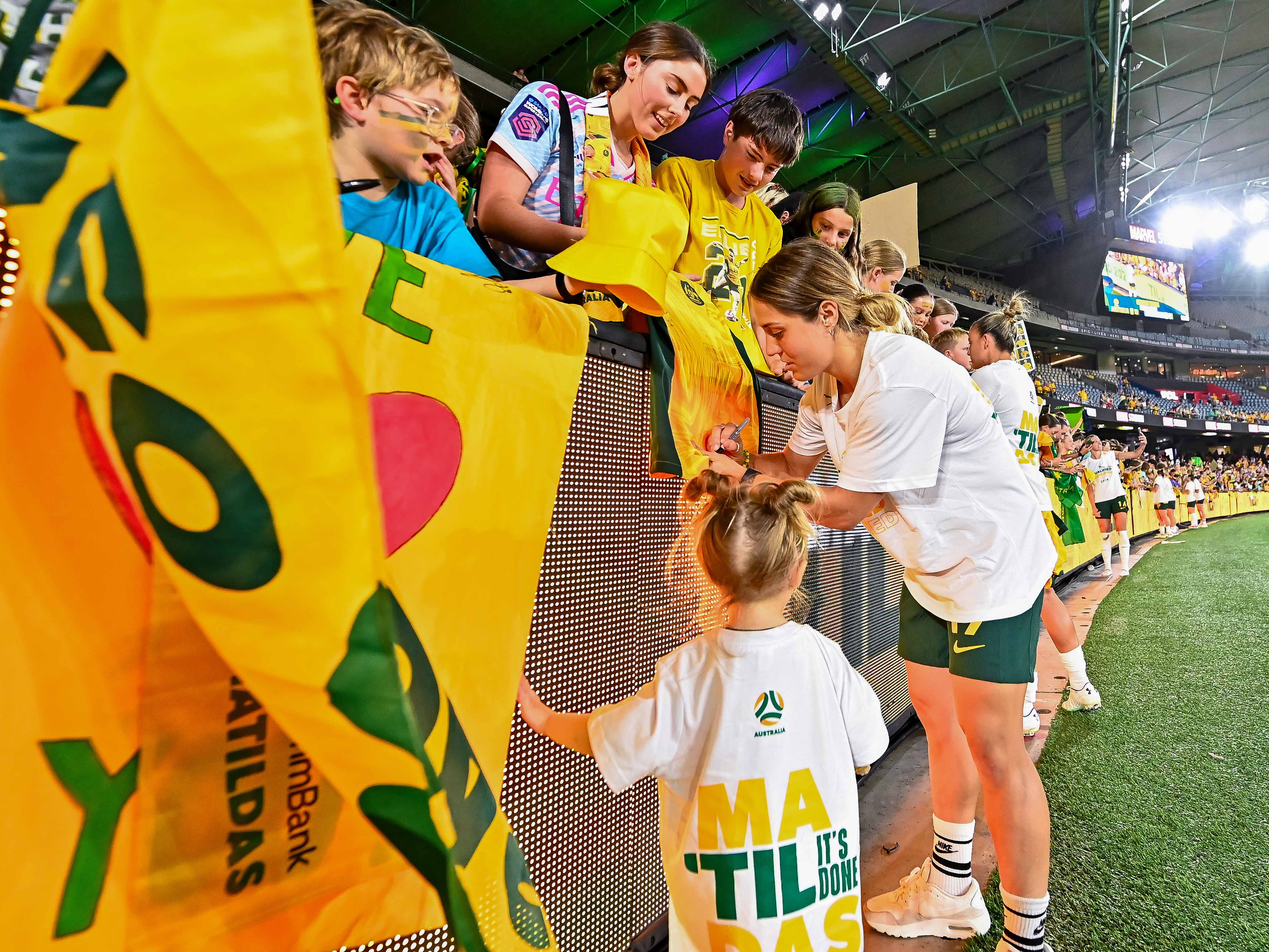 Katrina Gorry with daughter Harper following Australia's qualification for the Paris 2024 Olympic Games. (Photo: Kyoko Kurihara/Football Australia)