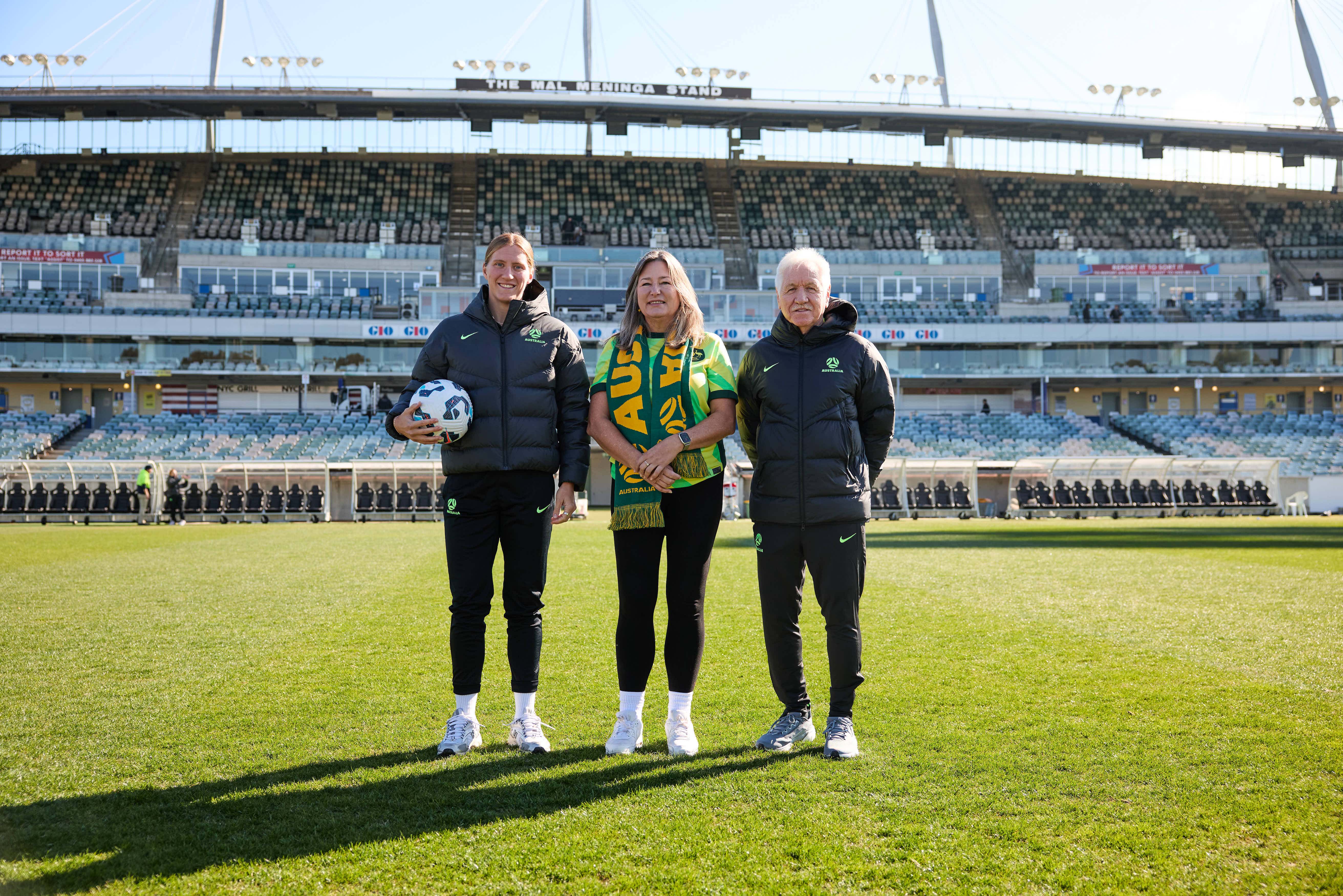 Defender Tash Prior, Yvette Berry MLA, Deputy Chief Minister and Minister for Sport and Recreation, and Interim Head Coach Tom Sermanni pose for a photo at GIO Stadium before Australia takes on Argentina. (Photo: Rachel Bach/By The White Line)