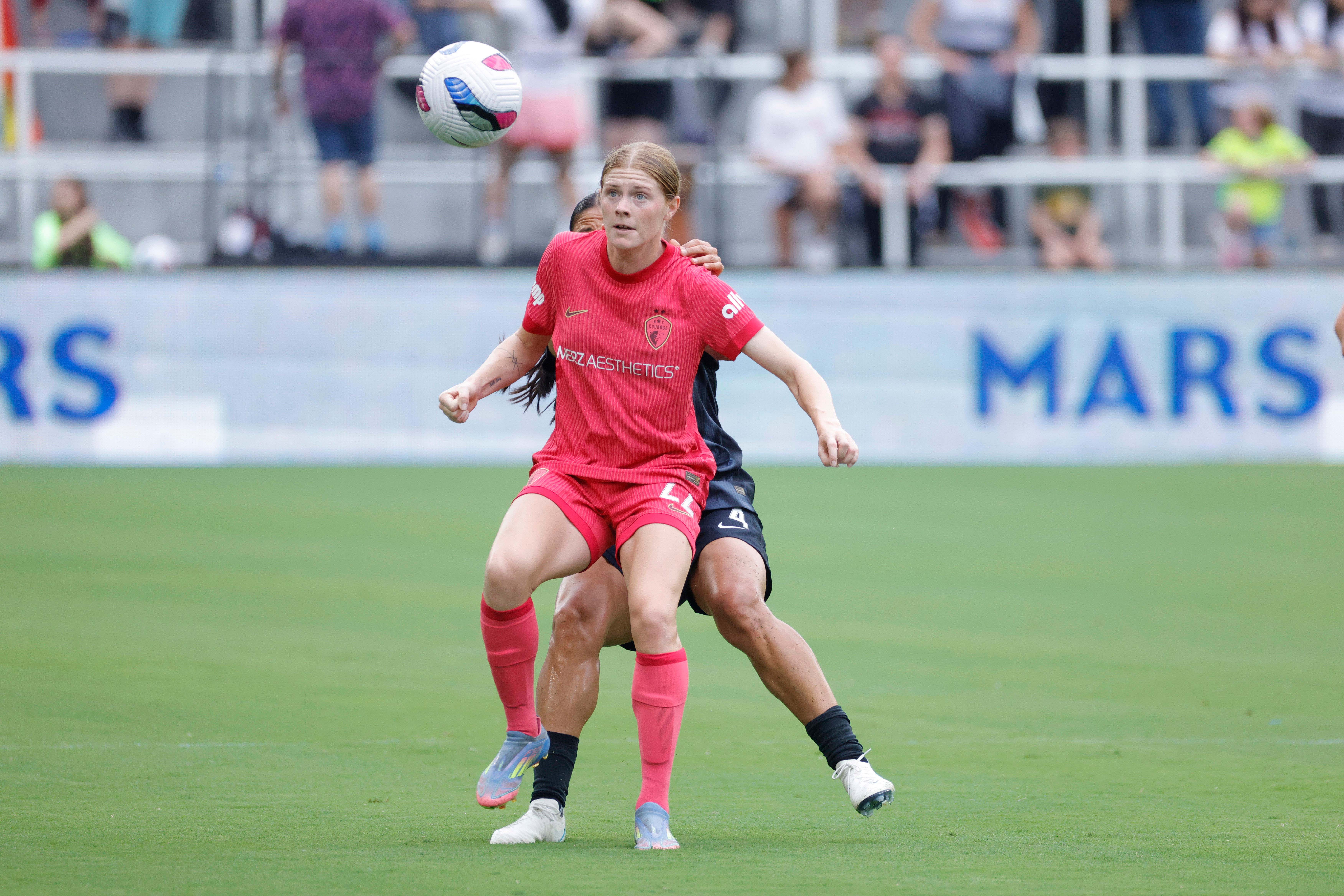 North Carolina Courage forward Cortnee Vine (22) battles for the ball with Washington Spirit defender Rebeca Bernal (4) during the first half at Audi Field.