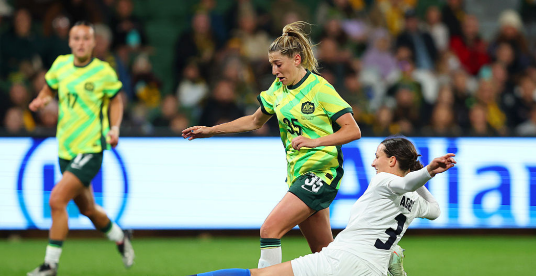 PERTH, AUSTRALIA - JUNE 29: Remy Siemsen of Australia is tackled by Sara Agrez of Slovenia during the International Friendly match between Australia Matildas and Slovenia at HBF Park on June 29, 2025 in Perth, Australia. (Photo by Paul Kane/Getty Images)