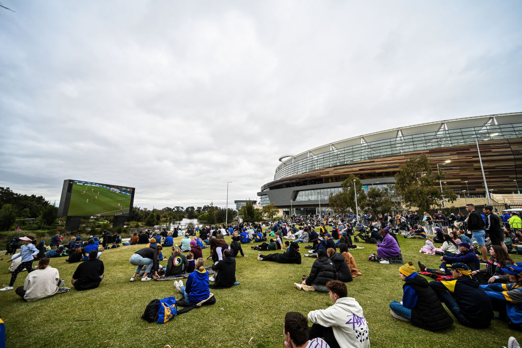 People gather outside of the stadium to watch the Matilda's World Cup match during the 2023 AFL Round 22 match between the West Coast Eagles and the Fremantle Dockers at Optus Stadium on August 12, 2023 in Perth, Australia. (Photo by Daniel Carson/AFL Photos via Getty Images)