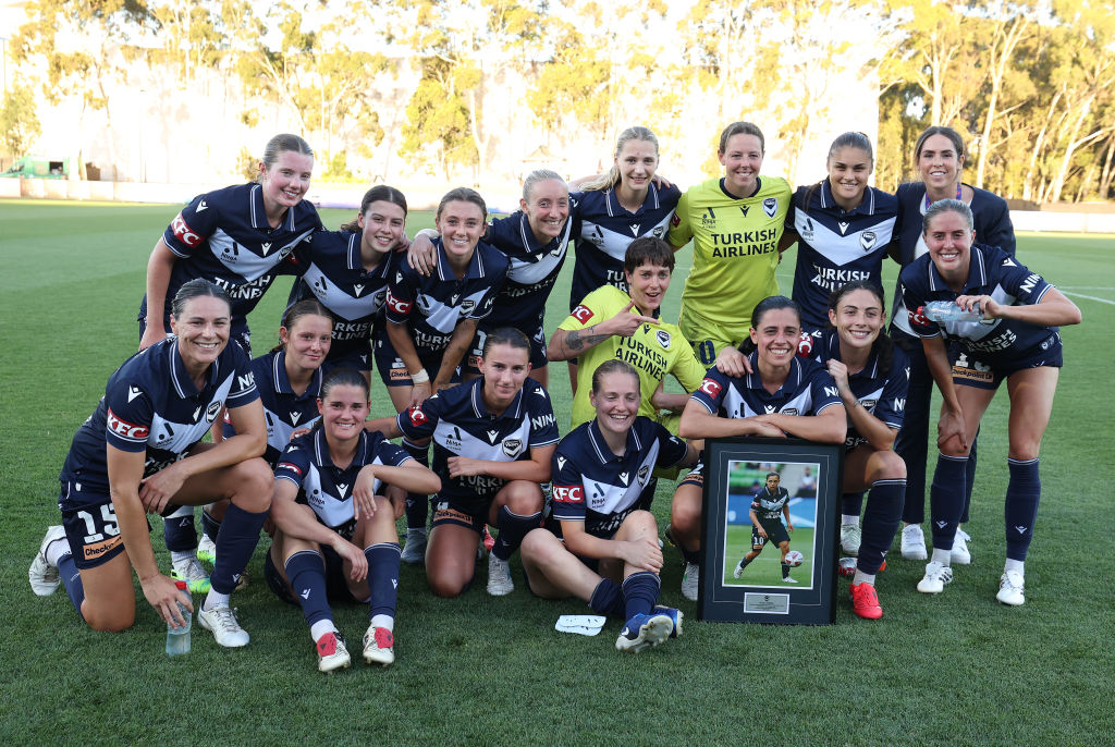 MELBOURNE, AUSTRALIA - JANUARY 18: Alexandra Chidiac of the Victory poses with her team mates after she was acknowledged after playing her 50th match during the round 12 A-League Women's match between Melbourne Victory and Perth Glory at Home of the Matildas, on January 18, 2025, in Melbourne, Australia. (Photo by Robert Cianflone/Getty Images)