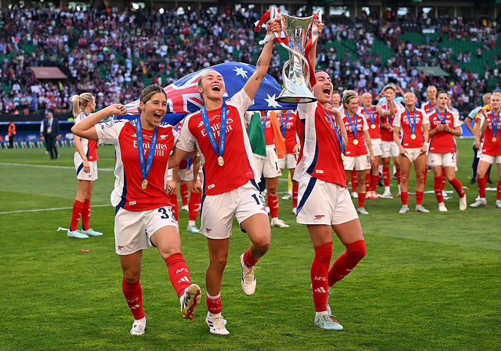 LISBON, PORTUGAL - MAY 24: Kyra Cooney-Cross, Caitlin Foord and Mariona Caldentey of Arsenal celebrate with the UEFA Women's Champions League trophy after the UEFA Women's Champions League final match between Arsenal WFC and FC Barcelona at Estadio Jose Alvalade on May 24, 2025 in Lisbon, Portugal. (Photo by David Ramos/Getty Images)