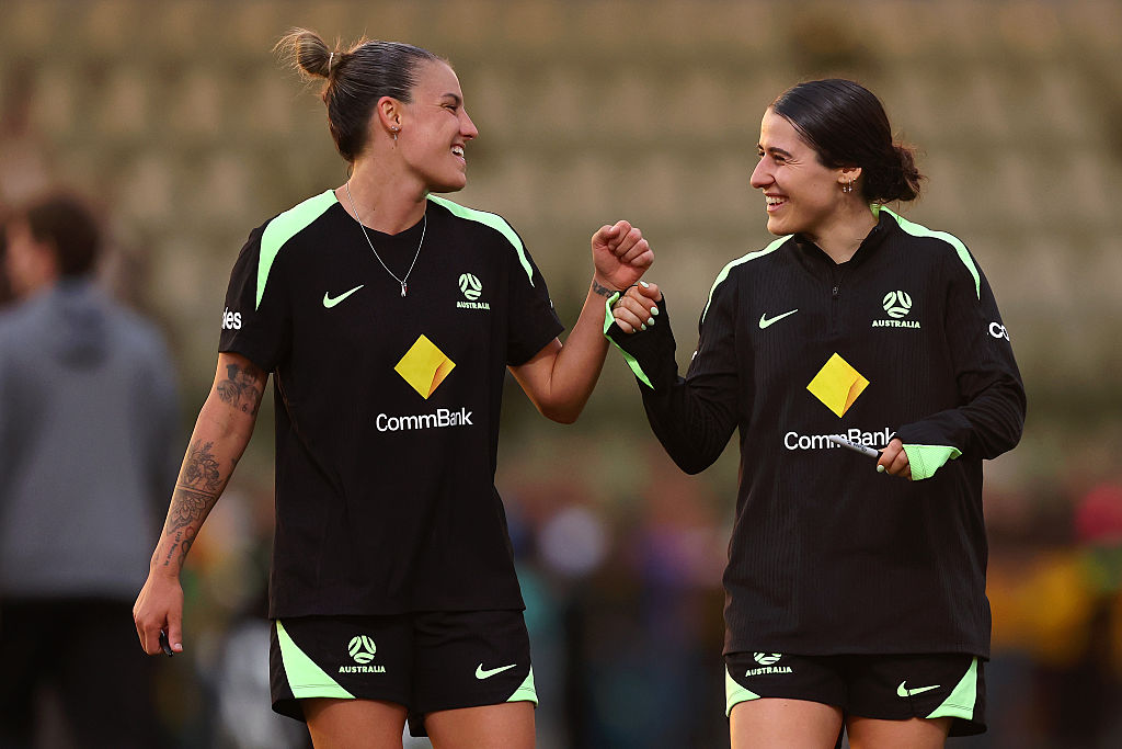 PERTH, AUSTRALIA - JULY 01: Chloe Berryhill and Adriana Taranto share a momentduring a Matildas training session at Sam Kerr Football Centre on July 01, 2025 in Perth, Australia. (Photo by Paul Kane/Getty Images)