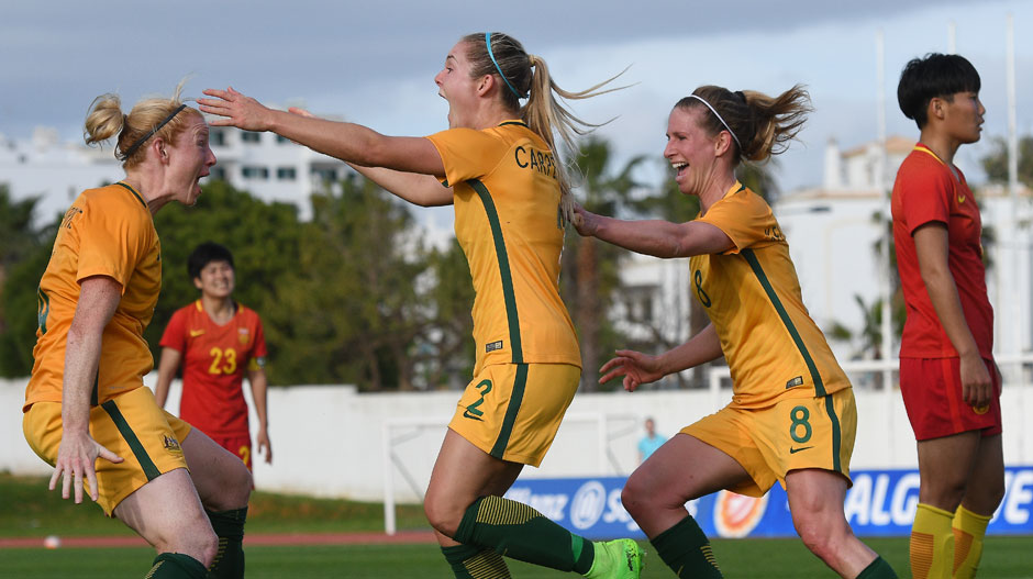 Westfield Matildas players celebrate with Ellie Carpenter after her late winner.