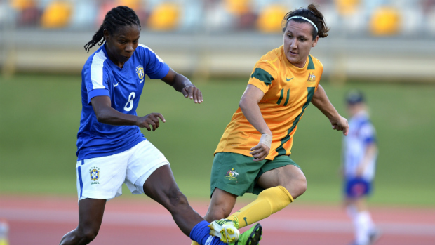 Lisa De Vanna plays the ball through Brazil's Miraildes Mota.