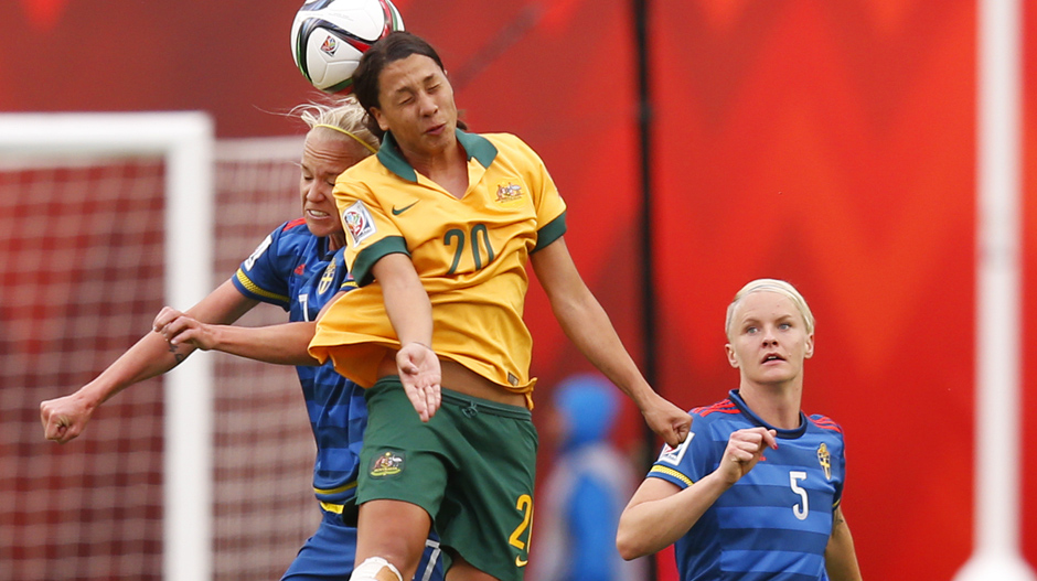 The hardworking Sam Kerr wins a strong header against Sweden.