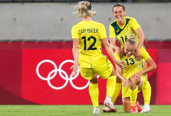 Tameka Yallop (Bottom R) celebrates with Australia's forward Hayley Raso (Rear R) and Australia's defender Ellie Carpenter after opening the scoring during the Tokyo 2020 Olympic Games women's group G first round football match between Australia and New Zealand at the Tokyo Stadium in Tokyo on July 21, 2021. (Photo by Yoshikazu TSUNO / AFP) (Photo by YOSHIKAZU TSUNO/AFP via Getty Images)