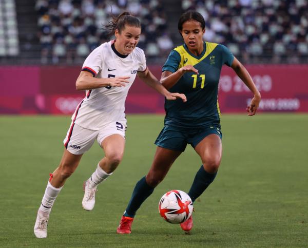  Kelley O'Hara #5 of Team United States looks to break past Mary Fowler #11 of Team Australia during the Women's Football Group G match between United States and Australia on day four of the Tokyo 2020 Olympic Games at Kashima Stadium on July 27, 2021 in Kashima, Ibaraki, Japan. (Photo by Atsushi Tomura/Getty Images)
