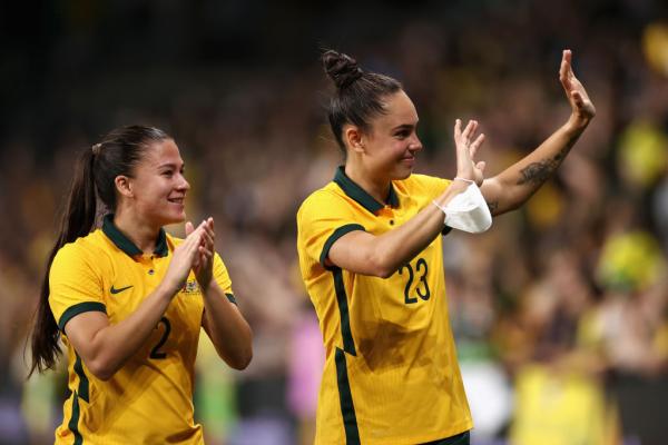 Angie Beard and Emma Checker applaud fans 