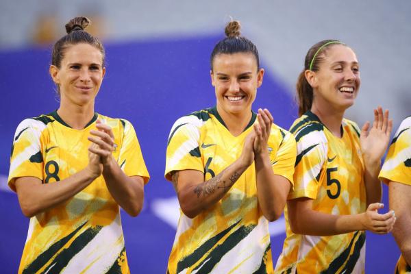 Elise Kellond-Knight , Chloe Logarzo and Karly Roestbakken of the Matildas share a laugh after the national anthem before the Women's Olympic Football Tournament Qualifier match between the Australian Matildas and Chinese Taipei at Campbelltown Sports Stadium on February 07, 2020 in Sydney, Australia. (Photo by Mark Kolbe/Getty Images)