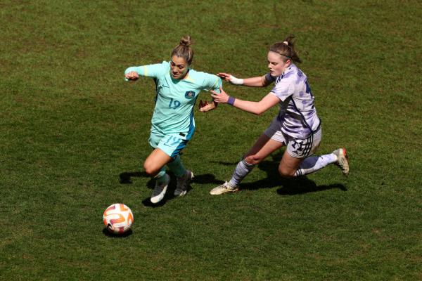 Katrina Gorry of Australia battles for possession with Emma Watson of Scotland during the Women's International Friendly match between Australia and Scotland at The Cherry Red Records Stadium on April 07, 2023 in Wimbledon, England. (Photo by Julian Finney/Getty Images)