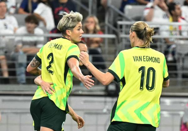 Australia's forward #2 Michelle Heyman celebrates with teammate after scoring during the SheBelieves Cup football match between USA and Australia at State Farm Stadium in Glendale, Arizona, on February 23, 2025. (Photo by Patrick T. Fallon / AFP) (Photo by PATRICK T. FALLON/AFP /AFP via Getty Images)