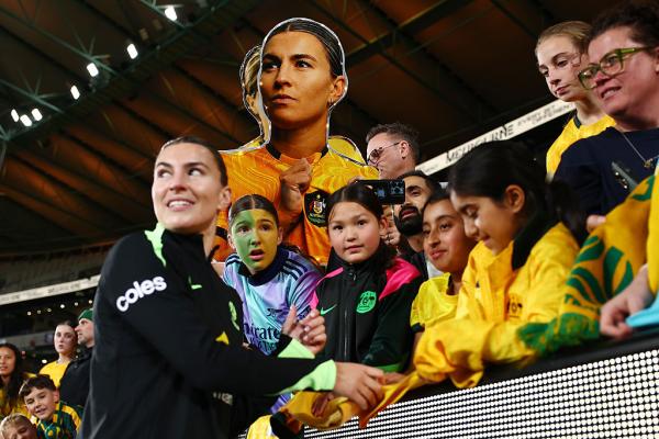MELBOURNE, AUSTRALIA - MAY 30: A fan holds up a sign as Steph Catley of Australia signs autographs during the International Friendly match between Australia Matildas and Argentina at Marvel Stadium on May 30, 2025 in Melbourne, Australia. (Photo by Morgan Hancock/Getty Images)