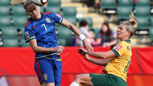 Elise Kellond-Knight competes for a header with Swedish midfielder Lisa Dahlkvist.