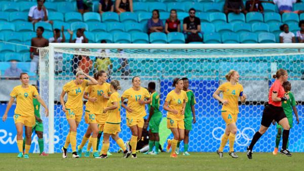 The Australian Women's Football Team celebrate one of their six goals against Zimbabwe at the Games.