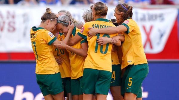 Matildas players celebrate one of Kyah Simon's two goals against Nigeria.