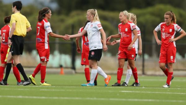 Wanderers and Lady Reds players shake hands at full-time in Sunday's 2-2 draw.