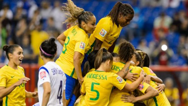 Brazil players celebrate Marta's second-half penalty against Korea Republic.