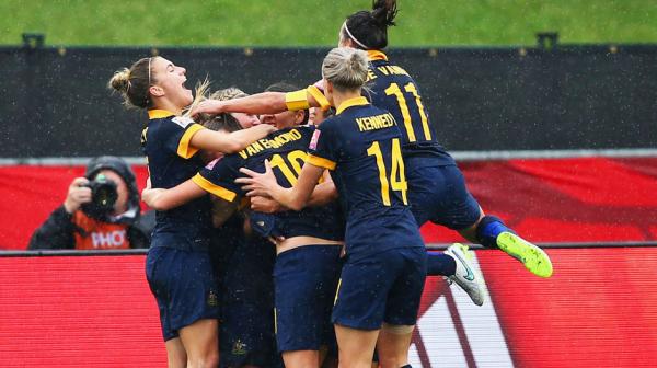 Matildas players celebrate Kyah Simon's goal against Brazil.