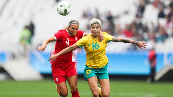 Striker Michelle Heyman is hauled back by her defender and she tries to surge towards goal.