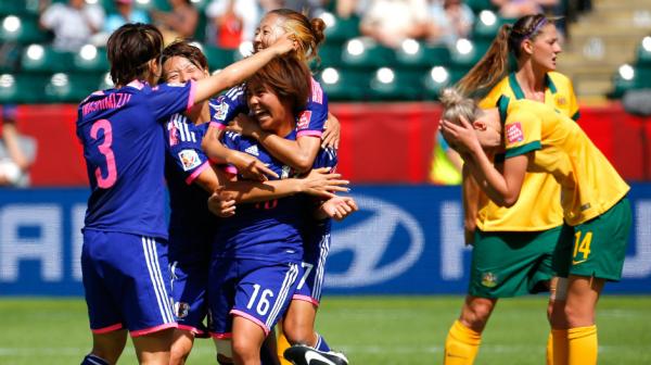 Japan players celebrate Mana Iwabuchi winner in Edmonton.