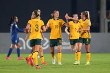 Emily van Egmond celebrates with her team mates after scoring against Thailand